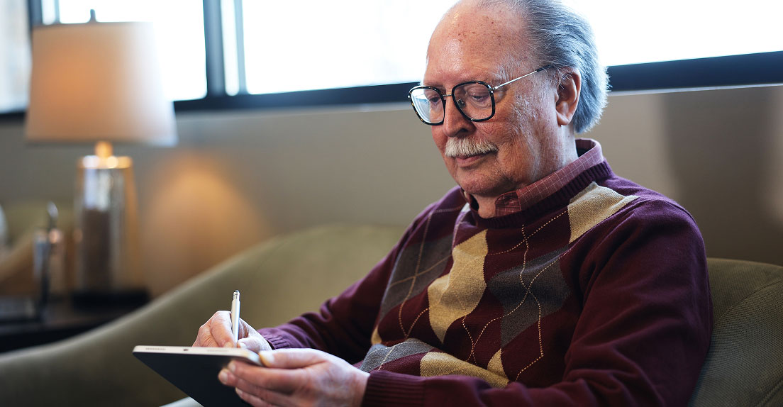 New patient completing dental implant intake form on a tablet at Indiana Implant Institute
